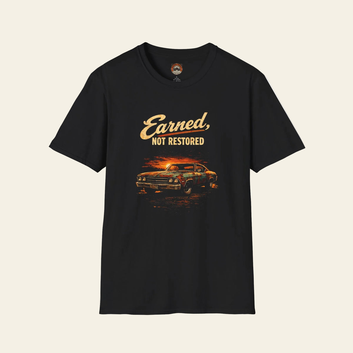 Black t-shirt with a vintage muscle car graphic and “Earned, Not Restored” lettering.
